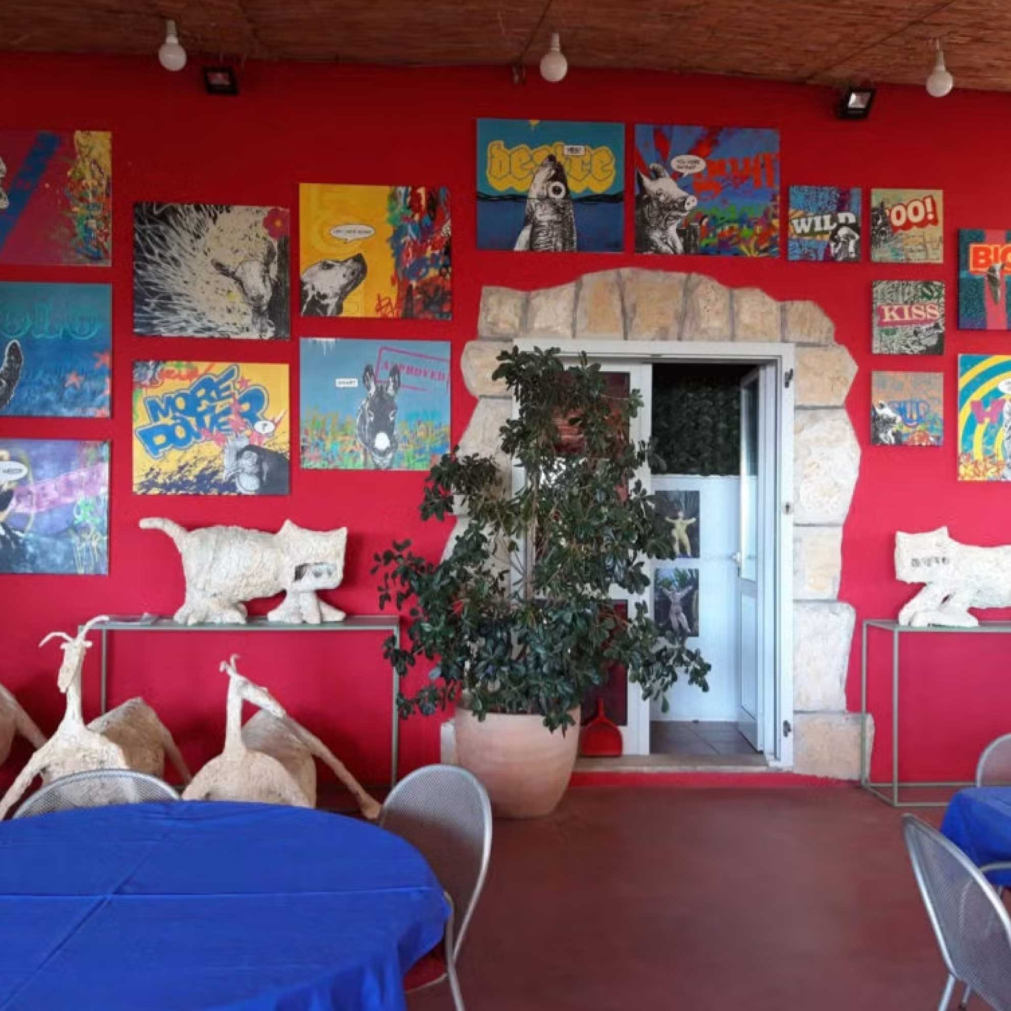 Studio Daboo paintings on a wall during an exhibition at Meneghello Palmizana art resort at Hvar Croatia